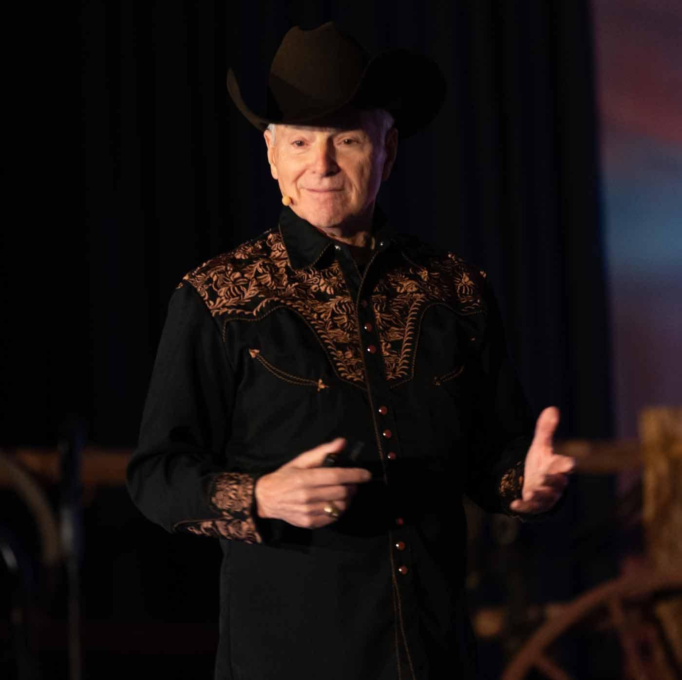 Jim performing in cowboy hat with guitar