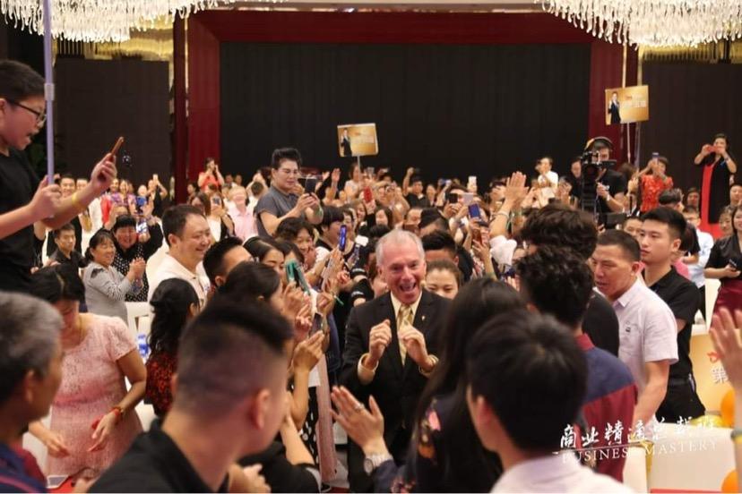 Jim Cathcart surrounded by audience at a China conference