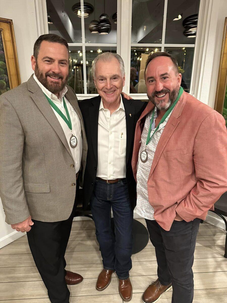 Jim Cathcart with two CPE recipients wearing their medallions