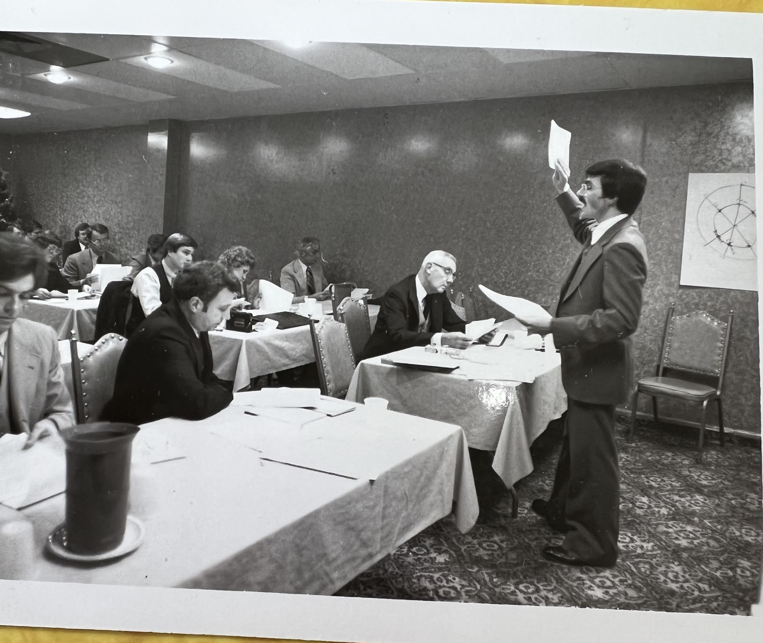 Young Jim Cathcart teaching in a seminar room, 1970s